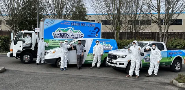 Green Attic LLC crew and owner Sadeq in front of branded vehicles